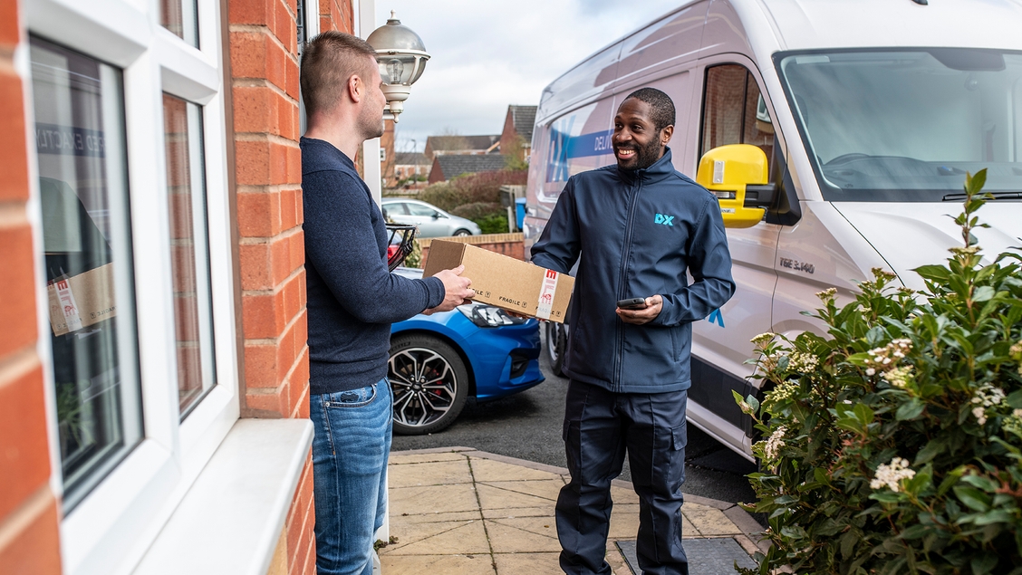 Dx Delivery driver giving customer a parcel on the doorstep