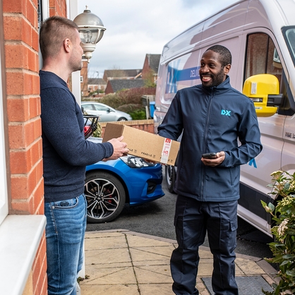 Dx Delivery driver giving customer a parcel on the doorstep